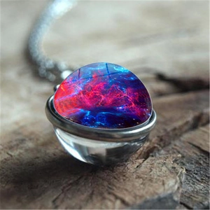 Macro shot of double-sided glass galaxy pendant necklace with cosmic nebula pattern