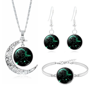 Detail of silver Sagittarius jewelry set including crescent moon necklace and earrings