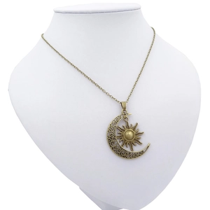 Vintage celestial sun and moon pendant necklace on white mannequin display