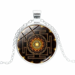 Silver Sri Yantra necklace featuring a geometric mandala glass pendant on a long chain