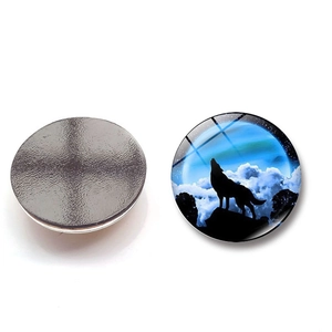 Round crystal glass fridge magnet featuring a howling wolf silhouette under northern lights