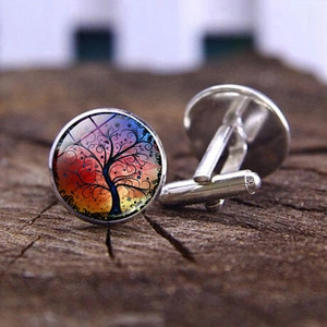 Silver tree of life glass cufflinks for men on rustic wood background with colorful art