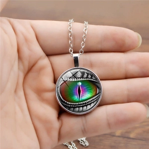 Detail of silver round evil dragon eye pendant necklace with colorful rainbow glass iris