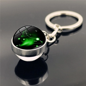 Macro view of Aries constellation crystal glass ball keychain with silver metal base