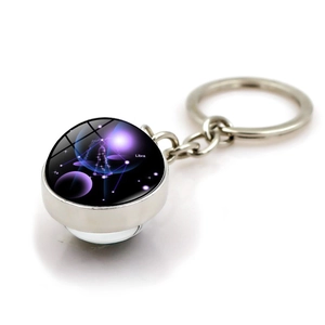 Silver zodiac keychain with Libra glass dome and blue galaxy constellation pattern