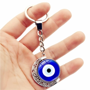 Porte-clés œil bleu turc avec croissant de lune en métal argenté et breloque rotative
