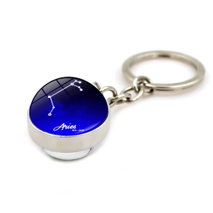 Luminous Aries zodiac glass ball keychain with blue starry night sky and silver metal ring
