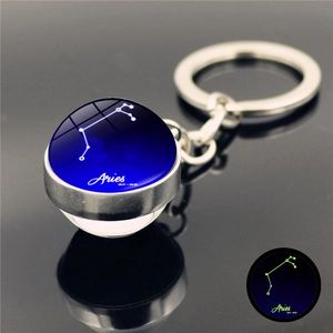 Luminous Aries zodiac glass ball keychain with starry constellation and date detail