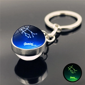 Luminous Gemini zodiac keychain with crystal glass ball showing constellation and dates