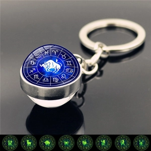 Luminous Taurus zodiac keychain with a glass dome glow-in-the-dark star pattern design
