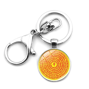 Detailed macro view of the Om mandala glass pendant with silver lobster clasp and keyring