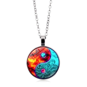 Macro detail of Yin Yang pendant with red fire and blue water glass art on silver chain