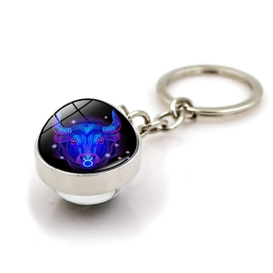 Detailed macro view of Taurus constellation keychain with glass dome and alloy base
