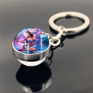 Macro side view of Aquarius glass ball keychain with silver metal frame and glowing nebula