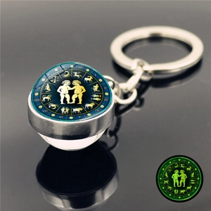 Porte-clés boule de verre Gémeaux lumineux avec anneau en métal et effet phosphorescent