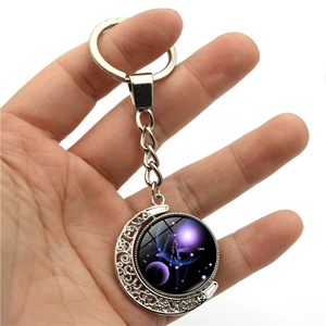 Luminous Libra zodiac moon keychain featuring a rotating purple nebula pendant in silver metal