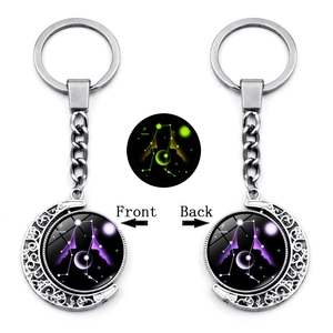Double-sided Gemini zodiac crescent moon keychain with luminous glow effect