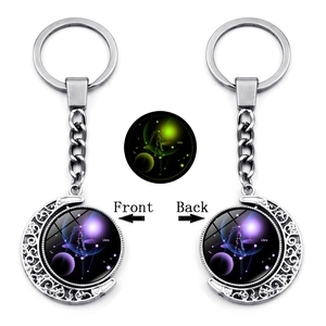 Rotating silver crescent moon keychain with luminous Libra zodiac sign and star chart