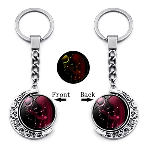 Detailed front and back views of silver Virgo zodiac rotating moon pendant keychain