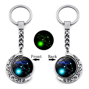 Luminous Taurus zodiac keychain with double-sided rotating moon pendant in silver finish