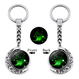 Luminous Aries zodiac keychain with rotating double-sided moon and green starlight glass orb