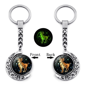 Luminous Aries zodiac keychain with double-sided rotating moon pendant in dark green glow