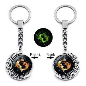 Luminous Pisces zodiac keychain featuring double-sided rotating moon pendant and green glow
