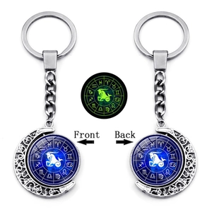 Luminous Capricorn moon keychain featuring double-sided rotating zodiac pendant and glow effect