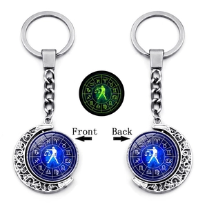 Detailed view of rotating Libra zodiac moon keychain with luminous effect in dark