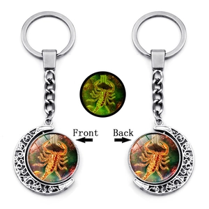 Detailed front and back views of Scorpio zodiac moon keychain with luminous glass gem