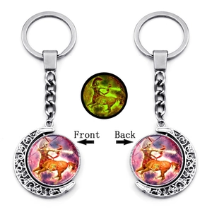 Luminous Sagittarius keychain with rotating moon pendant and double-sided zodiac design