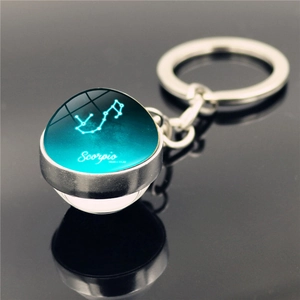 Macro shot of Scorpio constellation crystal ball keychain with silver metal finish