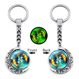 Glow-in-the-dark Pisces constellation rotating moon keychain with silver hollow frame