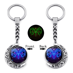 Glow-in-the-dark Aries constellation keychain with rotating moon and silver filigree