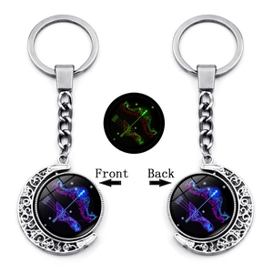 Detailed view of luminous Sagittarius zodiac moon keychain with rotating double-sided pendant