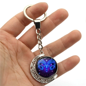 Luminous Aries zodiac moon keychain with rotating glass pendant in silver metal finish