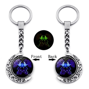 Luminous Gemini zodiac keychain with rotating double-sided moon crescent pendant