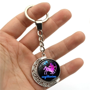 Glow Sagittarius constellation keychain with rotating moon pendant in metal and glass