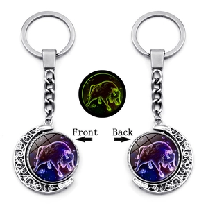 Luminous Taurus zodiac keychain with a rotating silver moon frame and glow-in-the-dark glass