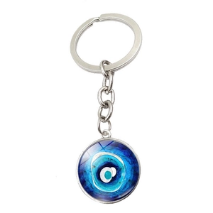 Macro view of blue Evil Eye glass pendant charm on silver metal keychain loop