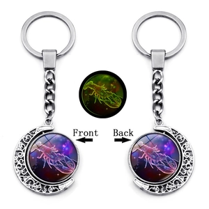 Luminous Cancer zodiac keychain featuring silver crescent moon and glowing starry glass dome