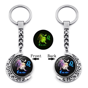 Luminous Leo zodiac keychain with rotating double-sided moon pendant in silver finish