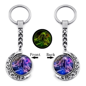 Detailed view of luminous crescent moon keychain with purple nebula fairy glass dome charm