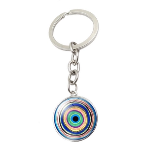 Close-up of Turkish Evil Eye pendant with colorful concentric rings on silver keychain