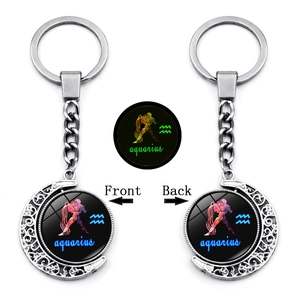 Glow-in-the-dark Aquarius constellation keychain with a rotating silver crescent moon
