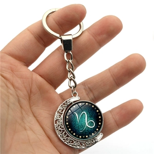 Luminous Capricorn zodiac keychain with rotating blue star moon pendant and silver alloy ring