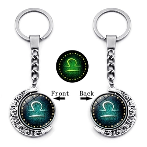 Glow in the dark Libra zodiac moon keychain with spinning silver constellation pendant