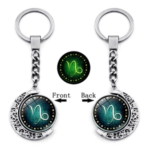 Luminous Capricorn constellation keychain with rotating moon pendant showing front and back