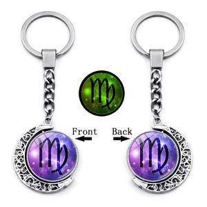Luminous Virgo constellation keychain featuring rotating glass gem and glow-in-the-dark effect