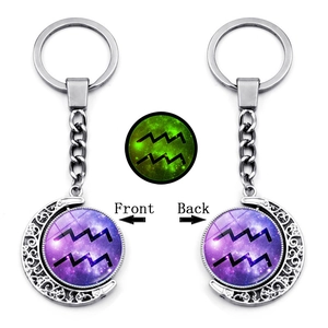 Detailed view of Aquarius glowing keychain with luminous crescent moon and star design